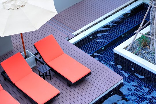 Orange Beach chairs side swimming pool