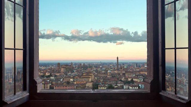 bologna cityscape as seen from behind a window day to night timelapse at the sunset to night city lighting up  panorama  4k
