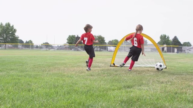 Children kicking soccer ball
