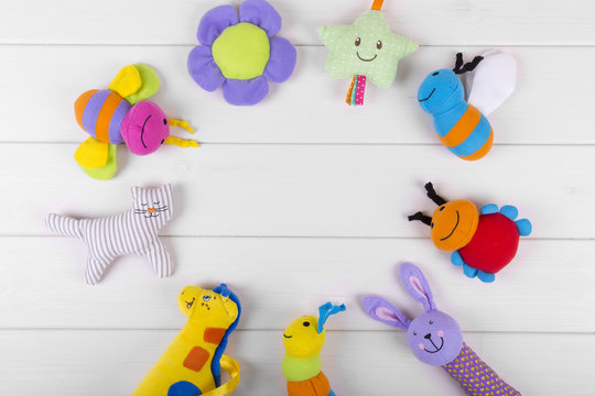 top view with soft baby toys on wooden background