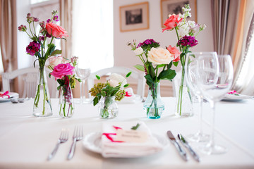 Wedding banquet, small restaurant. Floral decor in red, informal style.