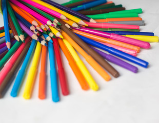 colored pencils and felt-tip pens on a white background