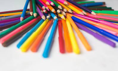 colored pencils and felt-tip pens on a white background