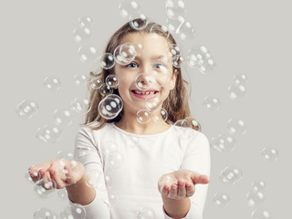 Girl playing with soap bubbles