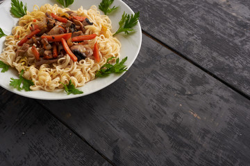 noodles on a plate on a wooden table
