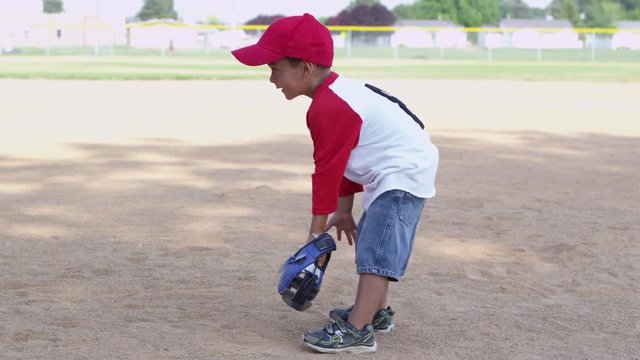 Little boy throwing baseball