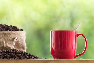 coffee mug wooden tabletop against grunge green blur background