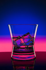 Drink in bar on color abstract background