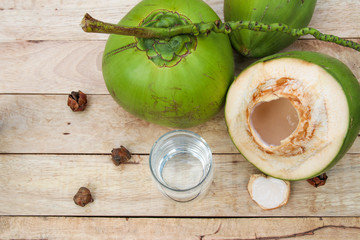 Fresh Coconut Water Drink in glass on wooden  background