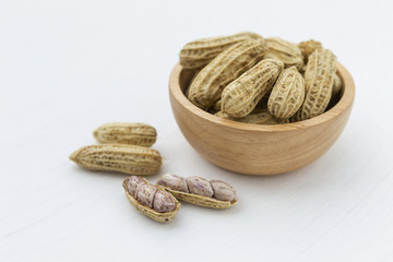 Closeup steamed peanut in wooden bowl on white background