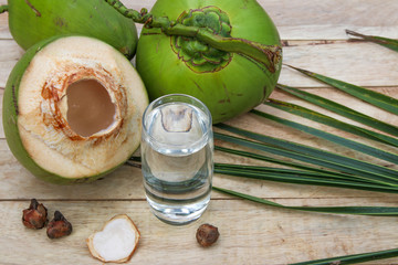 Fresh Coconut Water Drink with coconut leaf on wooden  background