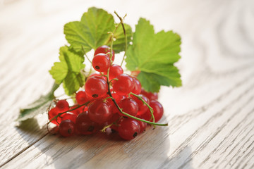 freshly picked red currant on oak wood table
