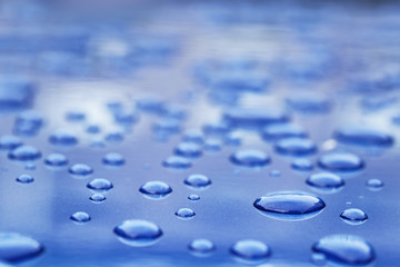 water drops on blue car body threated with protective coating