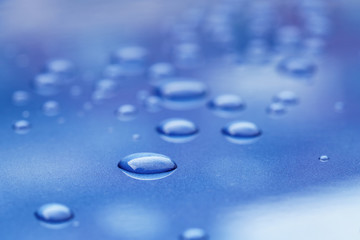 water drops on blue car body threated with protective coating