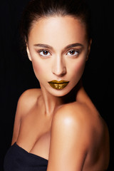 Beautiful model with bronze skin and gold lipstick. perfect skin texture.  - 119214417