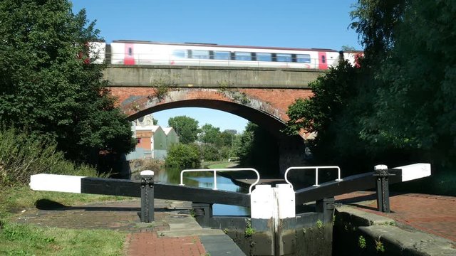 Train on a bridge going over the Grand Union Canal.