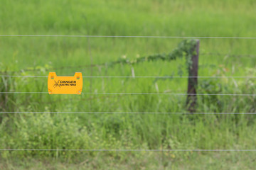 Warning on electric fence to prevent electric shock