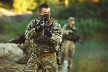 Fototapeta premium Special forces soldiers with weapon take part in military maneuv