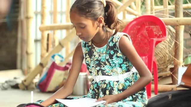 Girl studying in a village school in Bengal, India still medium shot, narrow depth of field.