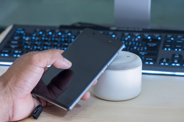Smartphone and NFC speaker,Using NFC application to connect with wireless speaker.NFC (Near Field Communication),selective focus.