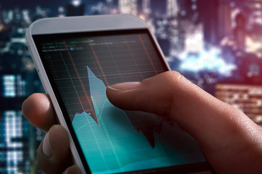 Making trading online on the smart phone in hand.