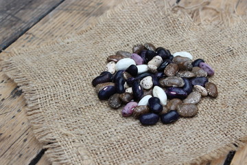 Fototapeta na wymiar Multicolored bean lying on sacking