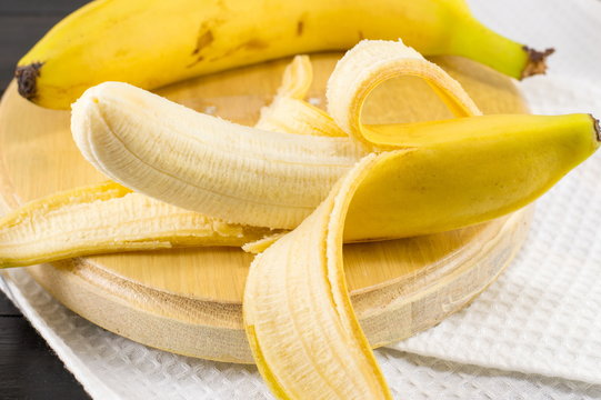 Fresh bananas on white textile