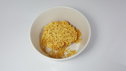 Instant noodles in a bowl on a white background