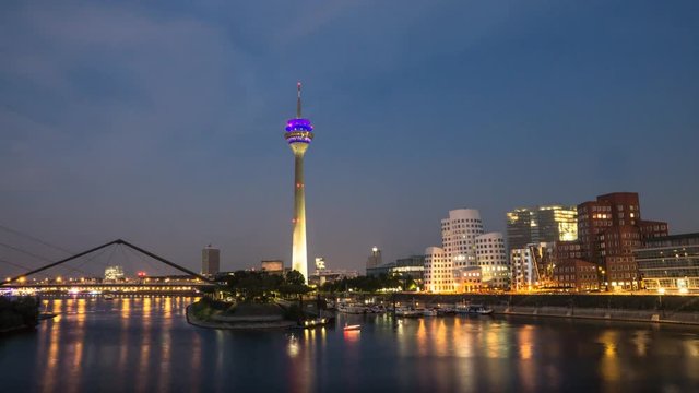 Reflection in the river rhine of the harbor district Dusseldorf in the evening