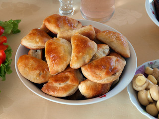  Dish with baked bacon patties on table close up       