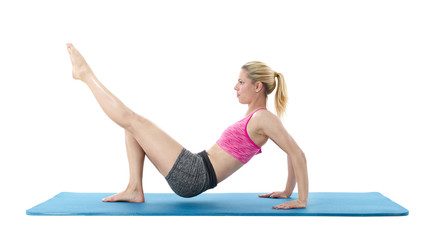 Fototapeta premium Young woman exercising on mat