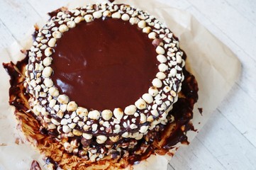 Icing a chocolate and hazelnut cake in the kitchen