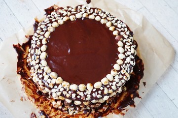 Icing a chocolate and hazelnut cake in the kitchen