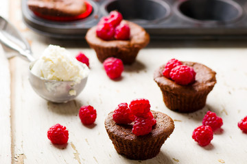 chocolate cake  with ice cream and raspberry.