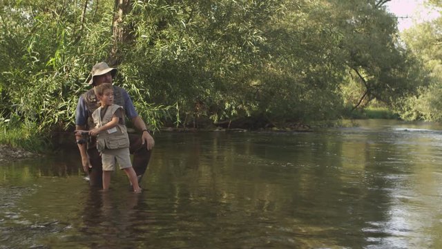 Father teaching son how to fish
