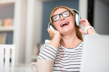 Overjoyed woman listening to music