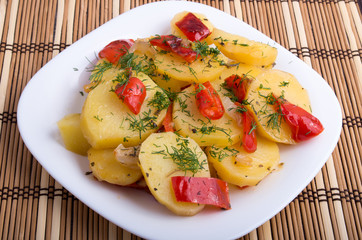 Closeup view on slices of potato stew with vegetables