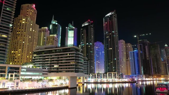 Dubai Marina night time lapse, United Arab Emirates. Dubai Marina - the largest man-made marina in the world. Dubai Marina is a canal city, carved along a 3 km stretch of Persian Gulf shoreline, UAE