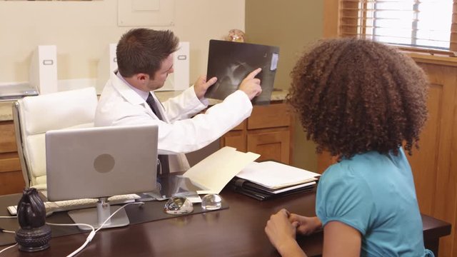 Doctor showing patient an xray