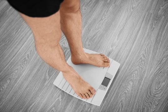 Man standing on weight scale