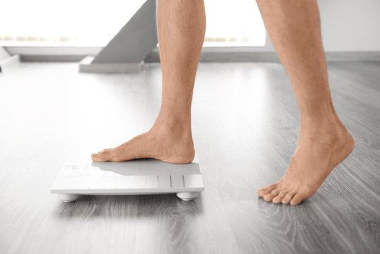 Man standing on weight scale