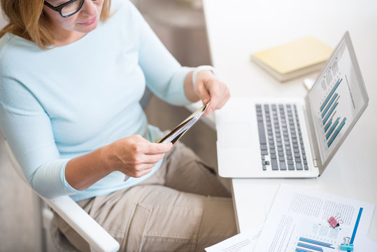 Pleasant Senior Woman Opening A Letter