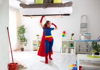 Sexy strong super hero woman holding bad in the air