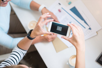 Pleasant colleagues sitting at the table
