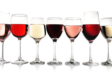 Glasses of rose, red and white wine isolated on white