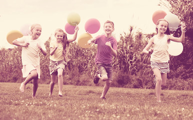 Girls and boy with balloons