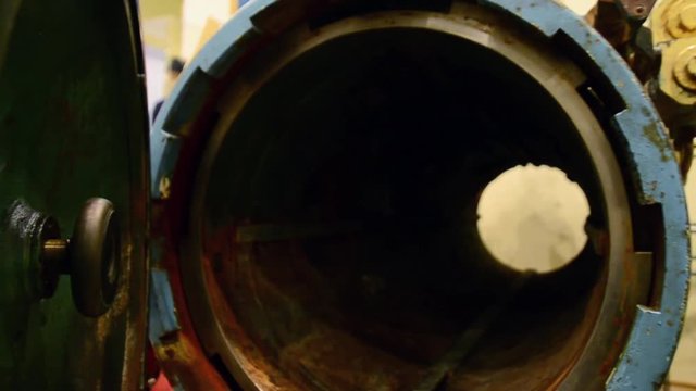 Hand open round iron hatchway passage of submarine in hall of fleet museum. Exhibit 