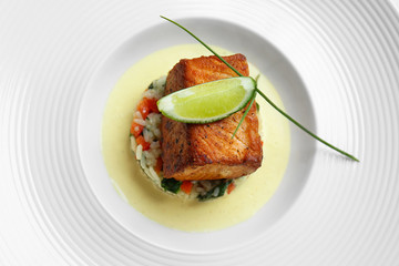 Delicious meat with rice and lime on white plate