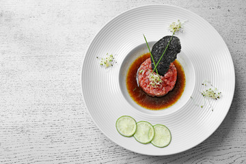 Delicious red fish with sauce and lime slices on white plate