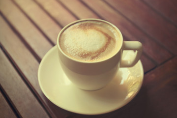 Cup of fresh coffee on wooden table